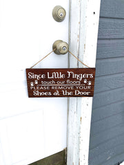 Since little fingers touch our floors please remove your shoes at the door wooden front door sign hung with twine. Remove your shoes sign