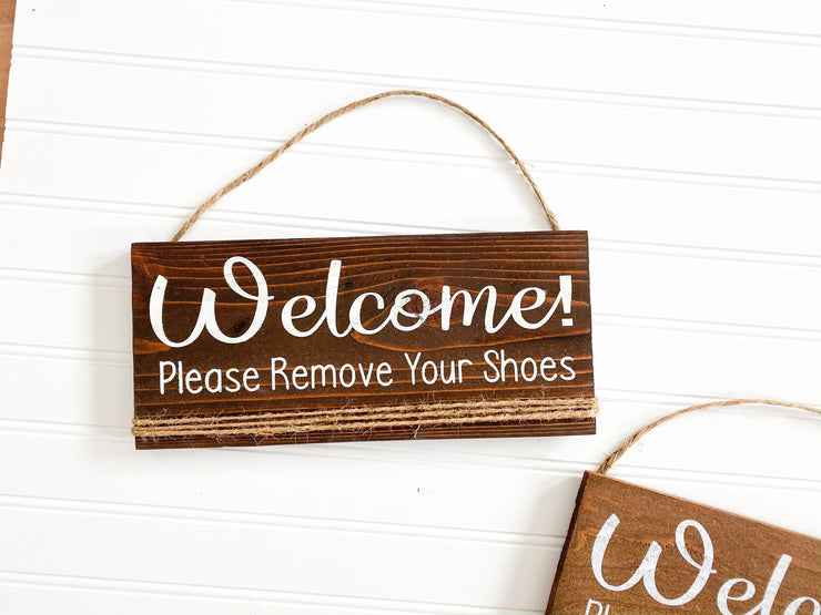 Welcome please remove your shoes wooden front door sign hung with twine. Hanging Welcome front door sign. Remove your shoes front porch sign