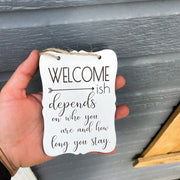 Welcome - ish. Depends on who you are and how long you stay. Small engraved entryway door sign. Front door, porch, patio small welcome sign