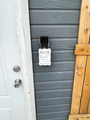 Welcome - ish. Depends on who you are and how long you stay. Small engraved entryway door sign. Front door, porch, patio small welcome sign