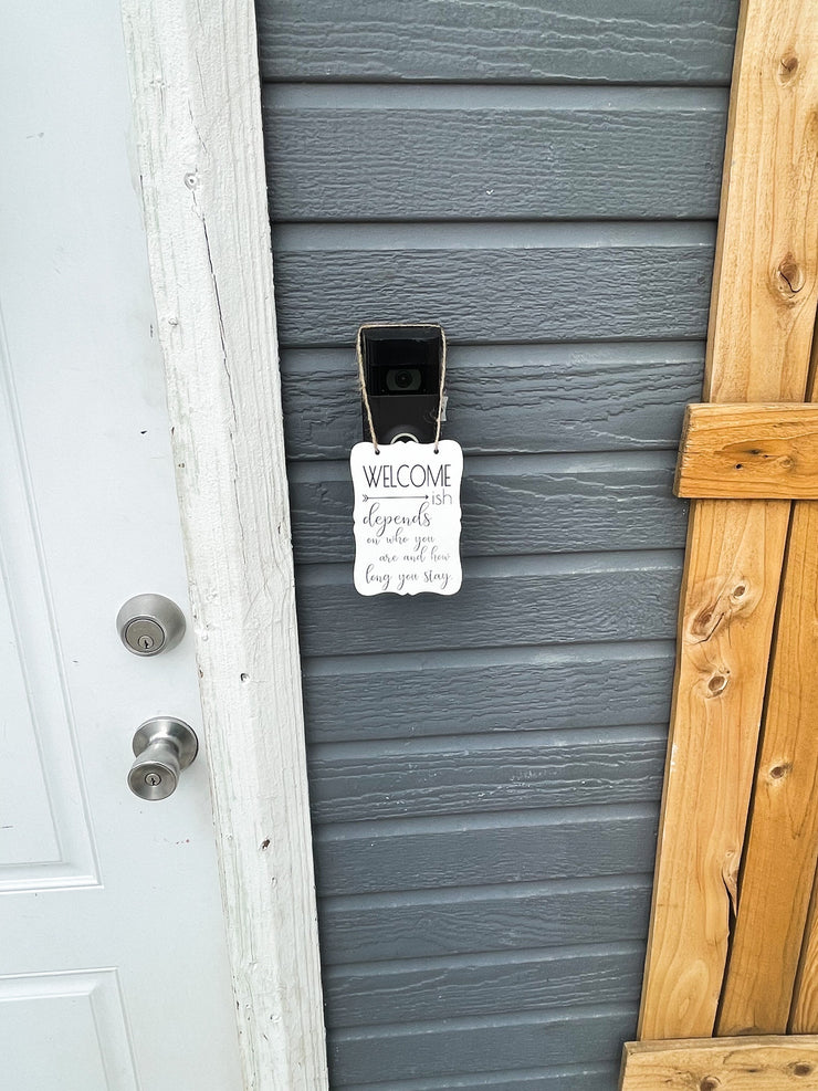 Welcome - ish. Depends on who you are and how long you stay. Small engraved entryway door sign. Front door, porch, patio small welcome sign