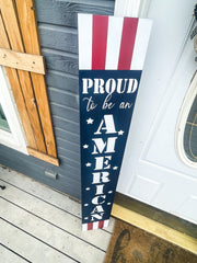 Proud to be an American with stars and stripes. Painted 4th of July patriotic sign. Front door porch leaner sign. Red, white and blue sign