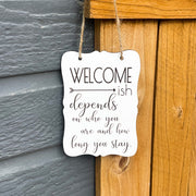 Welcome - ish. Depends on who you are and how long you stay. Small engraved entryway door sign. Front door, porch, patio small welcome sign