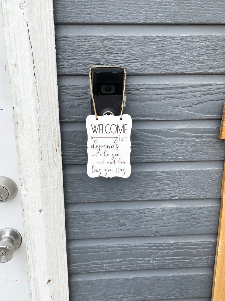 Welcome - ish. Depends on who you are and how long you stay. Small engraved entryway door sign. Front door, porch, patio small welcome sign