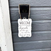 Welcome - ish. Depends on who you are and how long you stay. Small engraved entryway door sign. Front door, porch, patio small welcome sign
