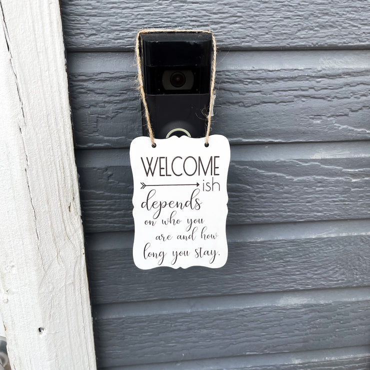 Welcome - ish. Depends on who you are and how long you stay. Small engraved entryway door sign. Front door, porch, patio small welcome sign