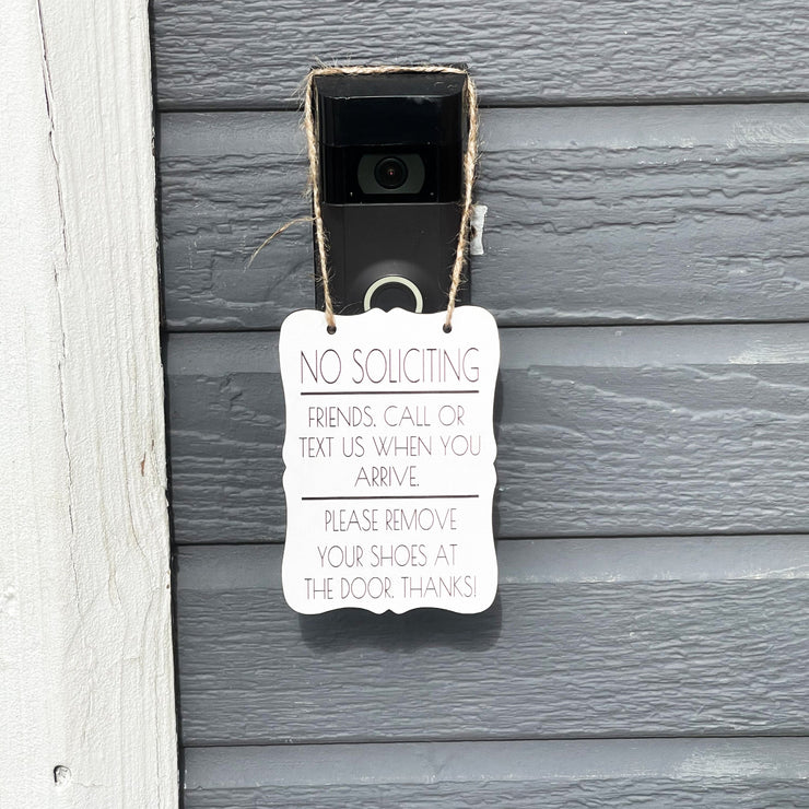 No Soliciting. Friends, call or text us when you arrive. Please remove your shoes at the door. Small front door sign. Hanging porch sign